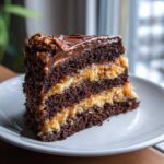 A tall, moist slice of german chocolate cake recipe with rich chocolate layers and coconut-pecan filling.