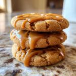 A stack of three soft maple cookies, rolled in sugar and topped with a thick caramel glaze.