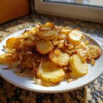 A plate piled high with perfectly golden brown fried potatoes and caramelized onions, showcasing the result of the recipe.