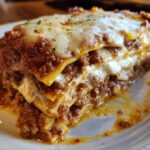 A thick, cheesy slice of homemade lasagna with rich meat sauce and melted mozzarella topping.