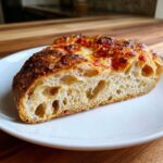 Cross-section view showing the airy, open crumb structure of sourdough discard pizza dough.