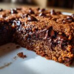 A close-up view showing the moist interior and melted chocolate chips of Chewy Chocolate Chip Cookie Bars.