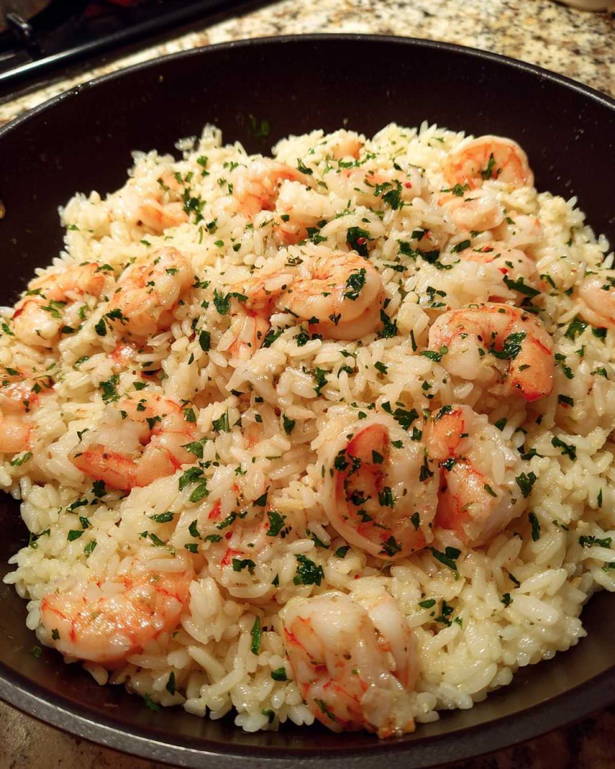 Close-up of Garlic Butter Shrimp and Rice Skillet, featuring plump shrimp mixed with rice and fresh parsley.