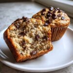 Close-up of a Gluten-Free Banana Chocolate Chip Muffin cut in half showing the moist interior and chocolate chips.