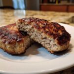 Close-up of a perfectly cooked Air Fryer Turkey Burger cut in half showing a juicy interior.