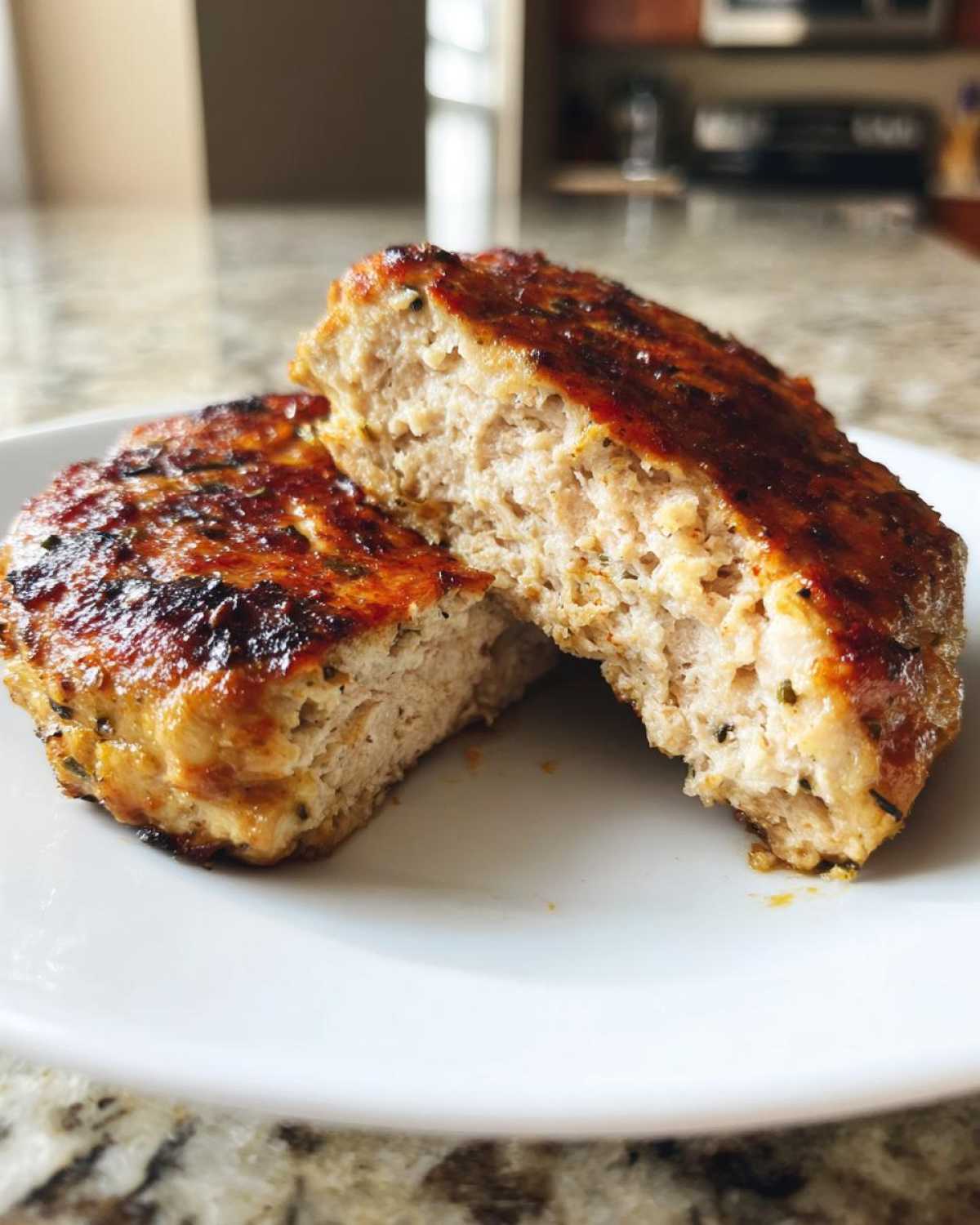 Close-up of a perfectly cooked Air Fryer Turkey Burger cut in half showing its juicy texture.