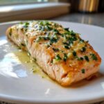 A perfectly cooked fillet of Keto Garlic Butter Salmon glistening with melted butter, garlic, and fresh parsley.