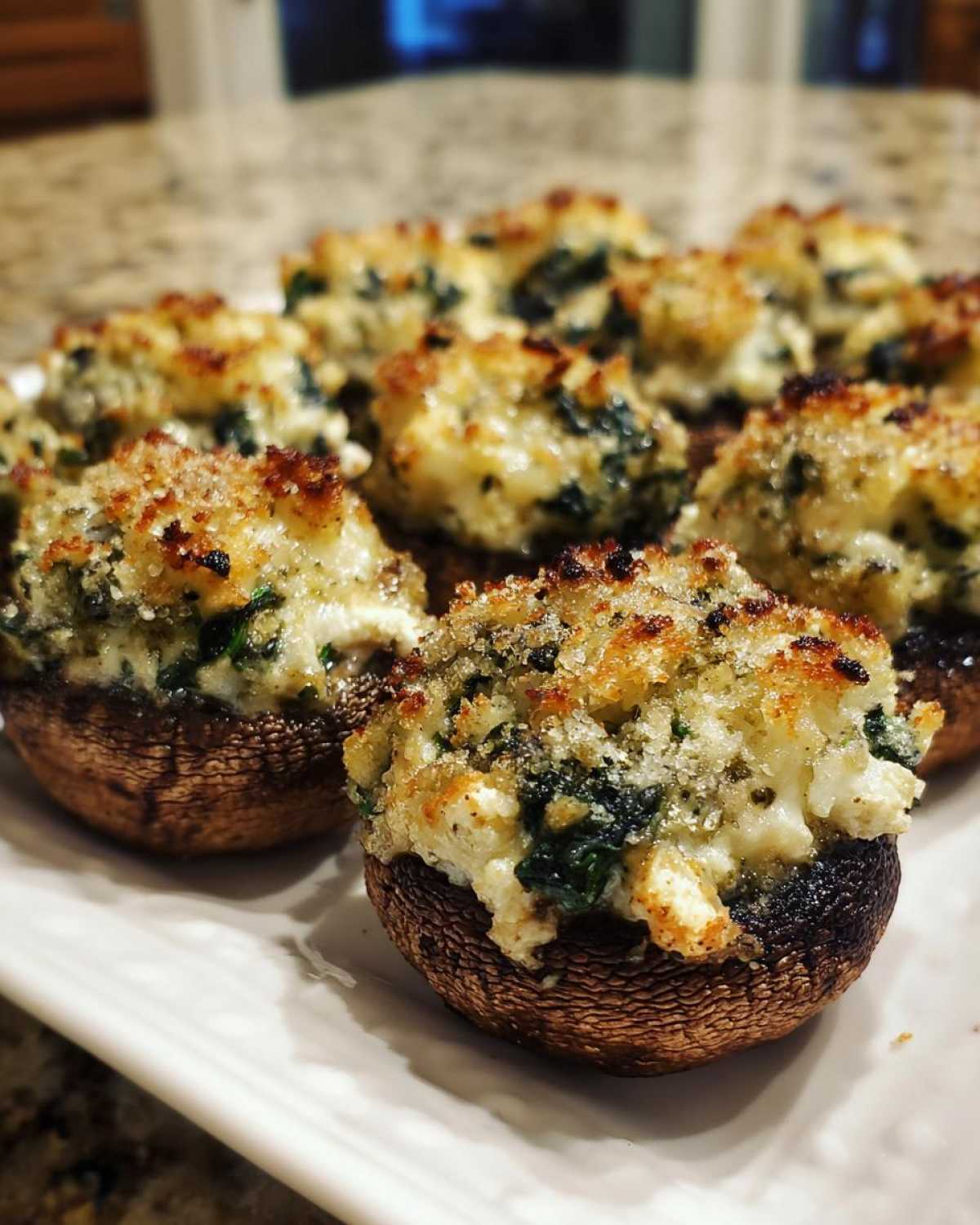 Close-up of baked Spinach and Feta Stuffed Mushrooms with a golden, crispy breadcrumb topping.