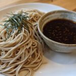 A serving of Cold Soba with Dipping Sauce, featuring chilled buckwheat noodles topped with shredded nori.