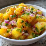 Close-up of vibrant Pineapple Habanero Salsa featuring chunks of pineapple, red onion, and cilantro in a white bowl.