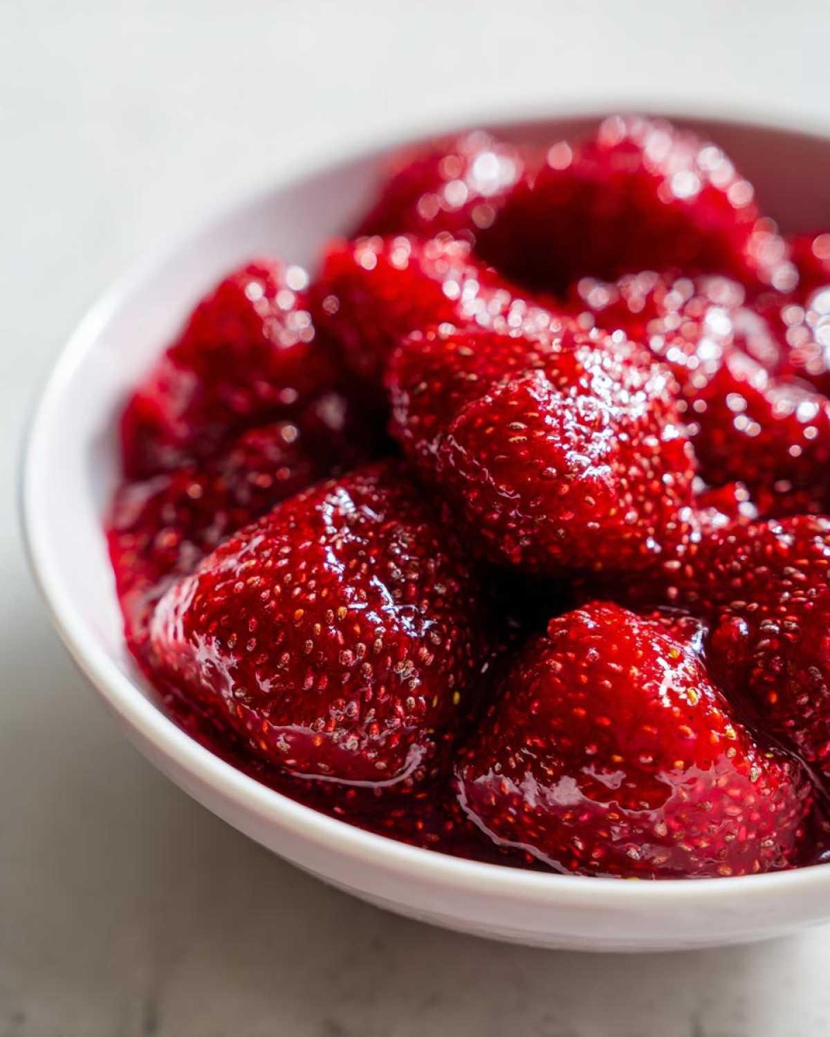 Close-up of macerated strawberries, showing seeds and glossy texture, ready for 10-Minute Strawberry Chia Jam.